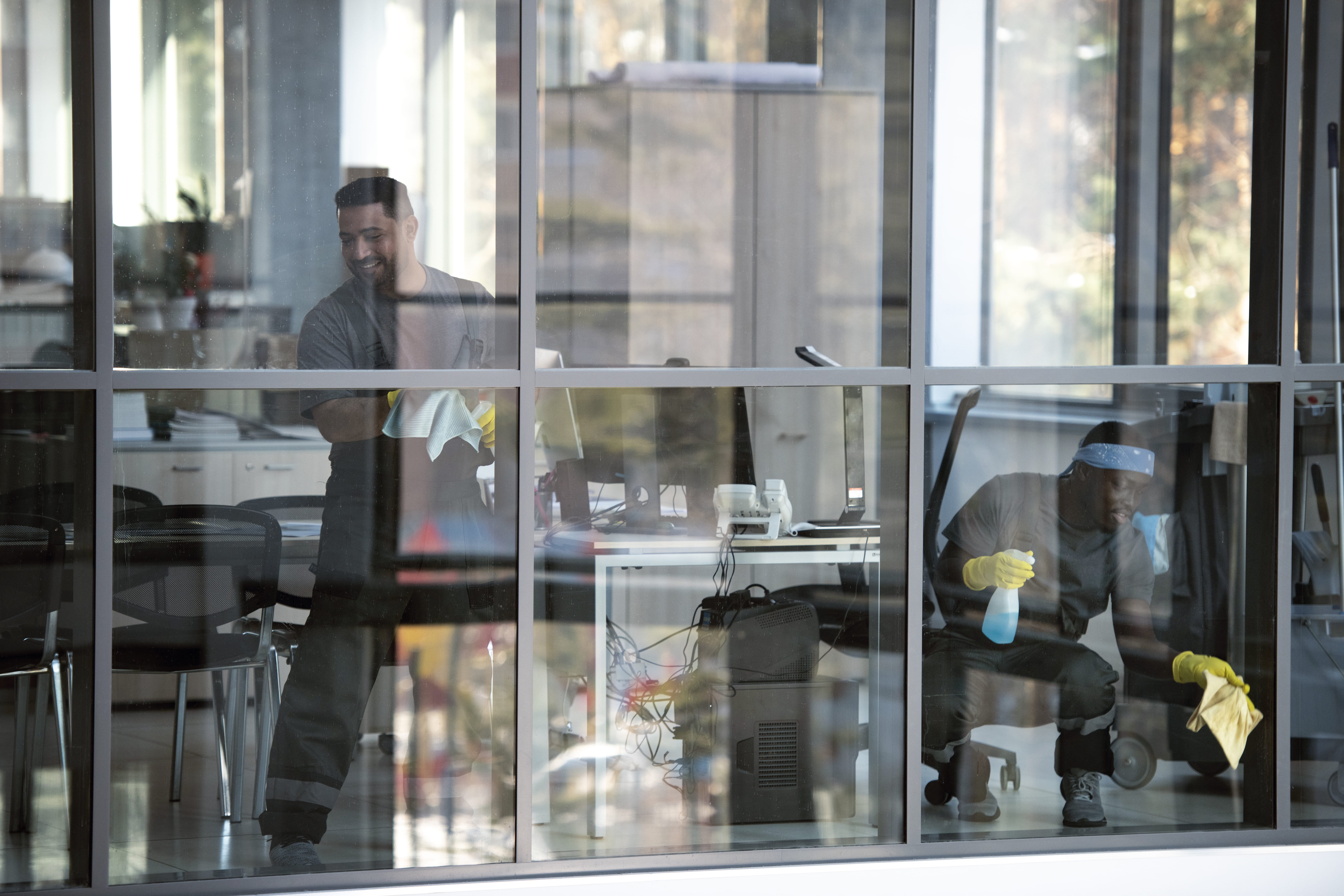 full shot smiley man cleaning window (1)